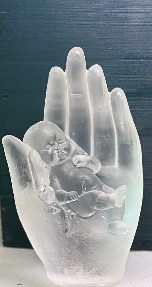 Hand holding baby